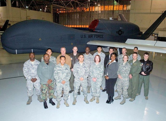 AFOTEC Detachment 5 personnel stand in front of a RQ-4 Global Hawk.