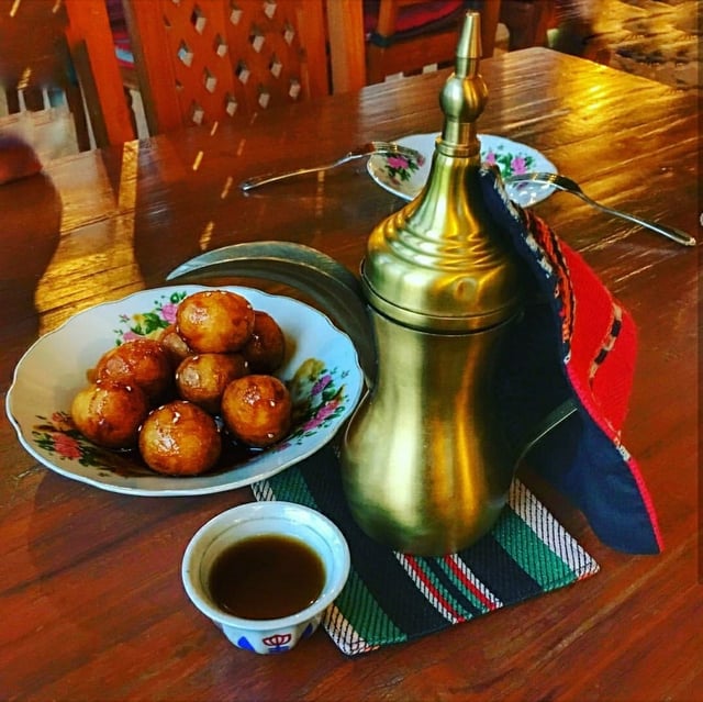 Arabic coffee with Lugaimat; a traditional Emirati sweet.