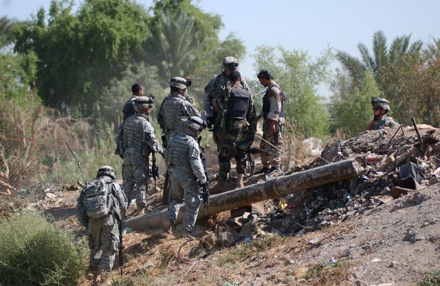 Iraqi National Police and U.S. Army Soldiers from the 2nd Battalion, 506th Infantry Regiment, discover a weapons cache in Dora, Baghdad on Oct. 8, 2006.