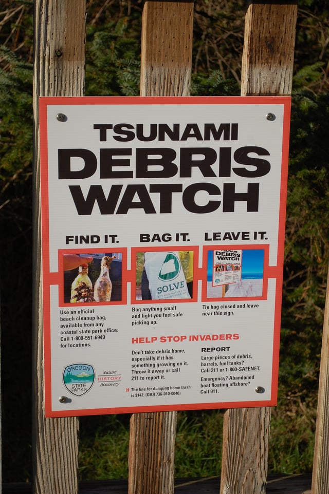 A sign informing beachgoers about proper tsunami debris disposal procedures at Cape Lookout State Park, Oregon, US