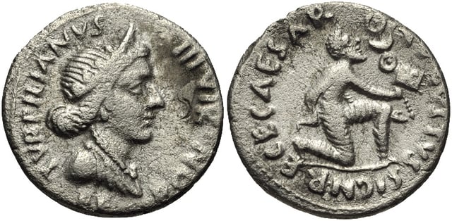 A denarius struck in 19 BC during the reign of Augustus, with the goddess Feronia depicted on the obverse, and on the reverse a Parthian man kneeling in submission while offering the Roman military standards taken at the Battle of Carrhae