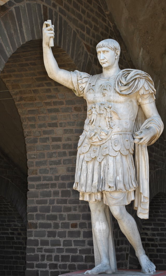 Statue of Trajan, posing in military garb, in front of the Amphitheater of Colonia Ulpia Traiana in the Xanten Archaeological Park