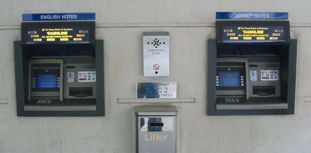 Twin cash machines at a bank that dispensed a choice of Bank of England or Jersey banknotes. Since the intervention of the Treasurer of the States in 2005, cash machines generally (with the exception of those at the airport and Elizabeth Harbour) no longer dispense British notes.