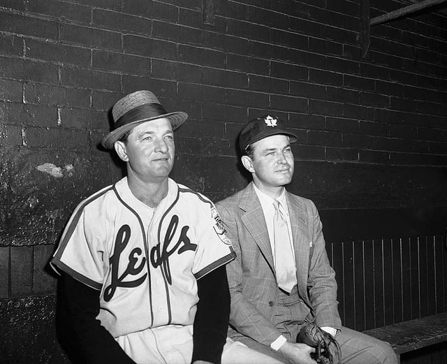 Jack Kent Cooke (right) swaps hats with Joe Becker, who managed the Maple Leafs in 1951–52.