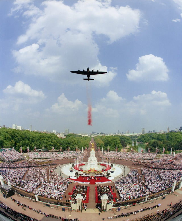 Britain remembers the 50th anniversary in 1995 with a Lancaster bomber dropping poppies in front of Buckingham Palace