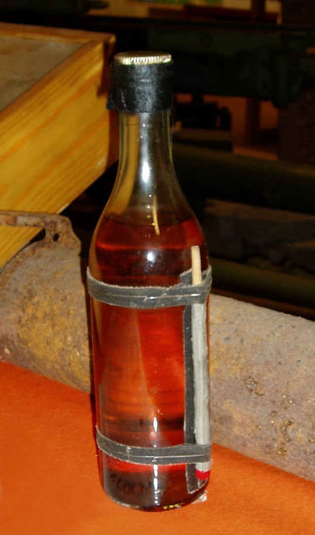 The original design of the Molotov cocktail produced by the Finnish alcohol monopoly Alko during the Winter War of 1939–40. The bottle has storm matches instead of a rag for a fuse.