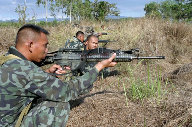Philippine marines using M16A1 rifles with M16A2 handguard during a military exercise
