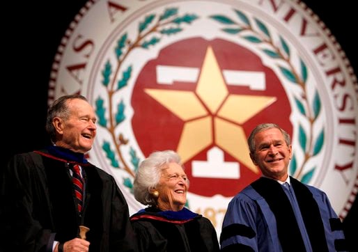 Then-President George W. Bush smiles with his parents, former President George H. W. Bush, left, and former First Lady Barbara Bush following his commencement address at Texas A&M's December 2008 convocation.