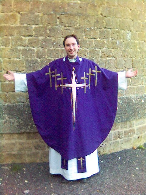 A priest in Eucharistic vestments.