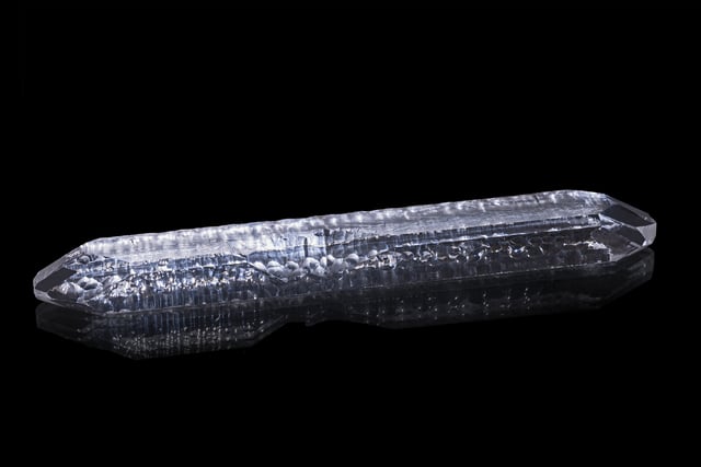 A synthetic quartz crystal grown by the hydrothermal method, about 19 cm long and weighing about 127 grams