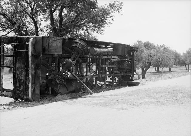 Result of terrorist acts and government measures. Remains of a burnt Jewish passenger bus at Balad Esh-Sheikh outside Haifa. Picture taken between 1934 and 1938.