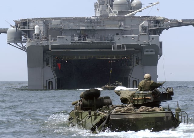 Assault Amphibious Vehicles approach the well deck of USS Bonhomme Richard