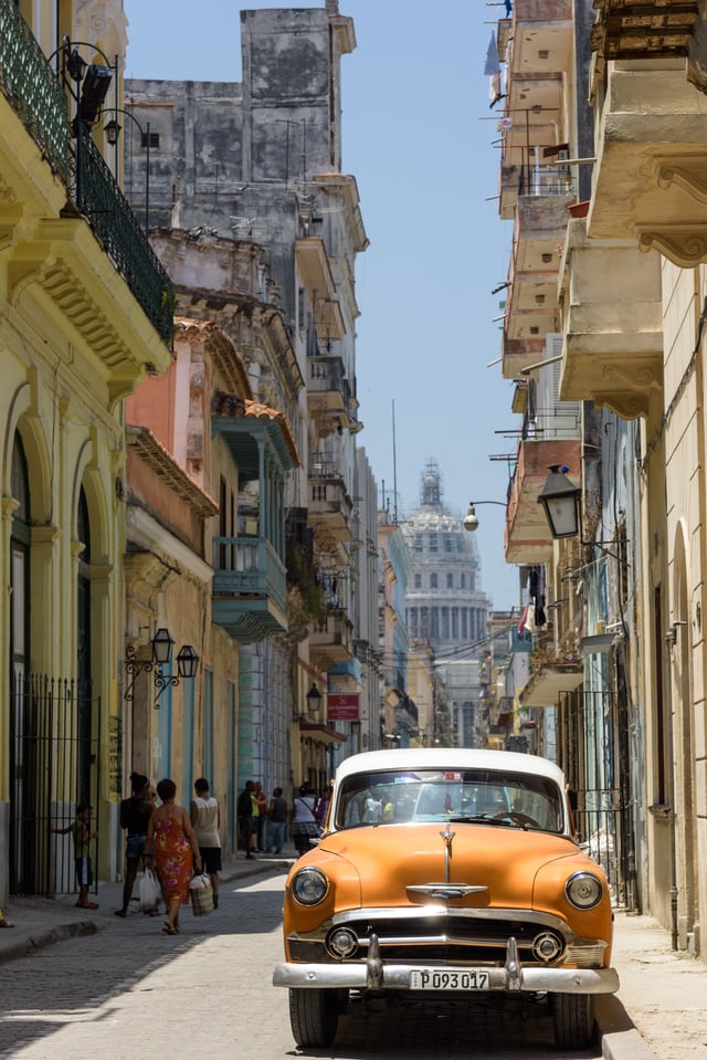 Old Havana from street level, with the Capitolio in the background.