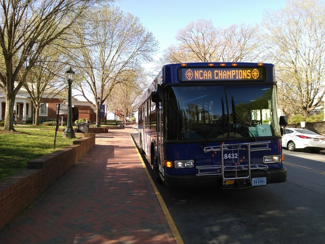 Northline Express (NLX) bus of the University Transit Service, with signage celebrating victory at the 2019 NCAA Tournament Championship ("March Madness")