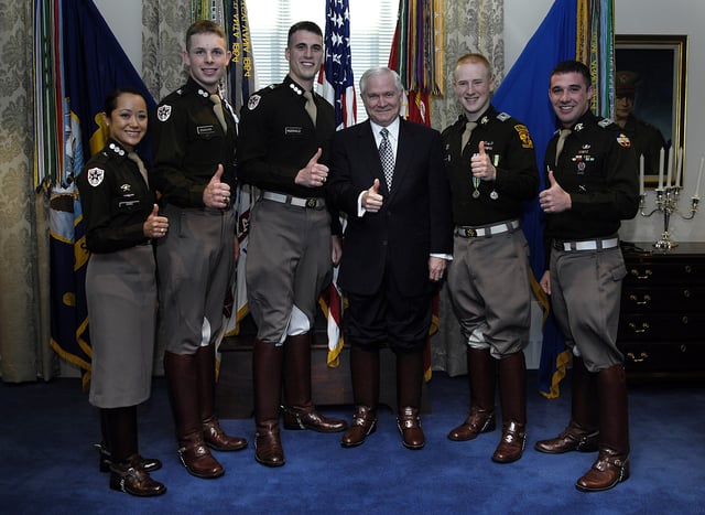 Robert Gates and senior cadets from the Corps of Cadets give the "gig 'em" sign at the Pentagon.