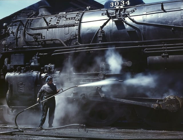 Steam-cleaning the running gear of an "H" class locomotive, Chicago and North Western Railway, 1943