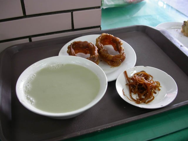 A bowl of douzhi (left) with breakfast items