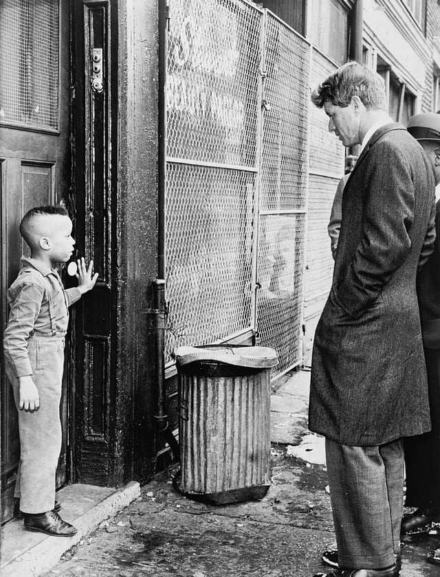 Senator Kennedy speaks with a boy while touring Bedford–Stuyvesant
