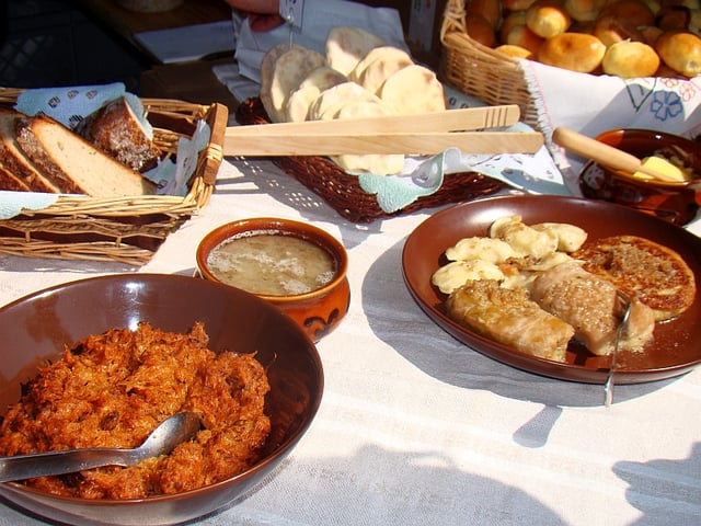 Selection of hearty traditional comfort food from Poland including bigos, cabbage rolls, żurek, pierogi, oscypek and specialty breads