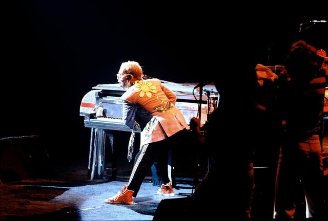 Elton John on the piano during a live performance in 1975