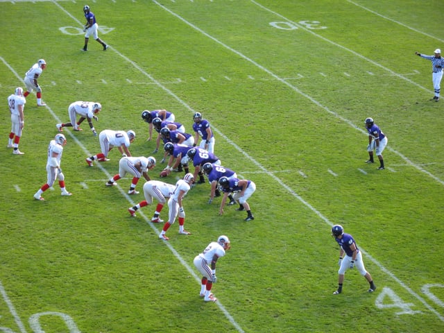 The College of the Holy Cross' football team (purple)