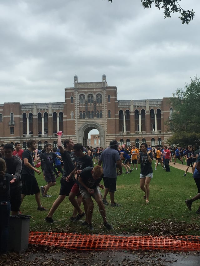 Rice University students participating in the Beer Bike water balloon fight in front of the Sallyport.
