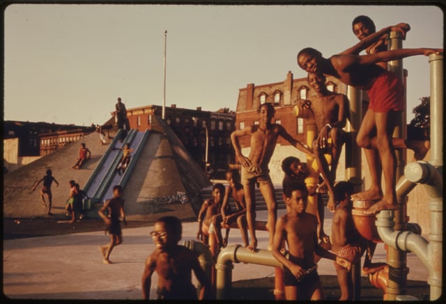 Youth play in an adventure playground at the "K-pool" public swimming pool in Bedford–Stuyvesant in July 1974.  Photo by Danny Lyon.