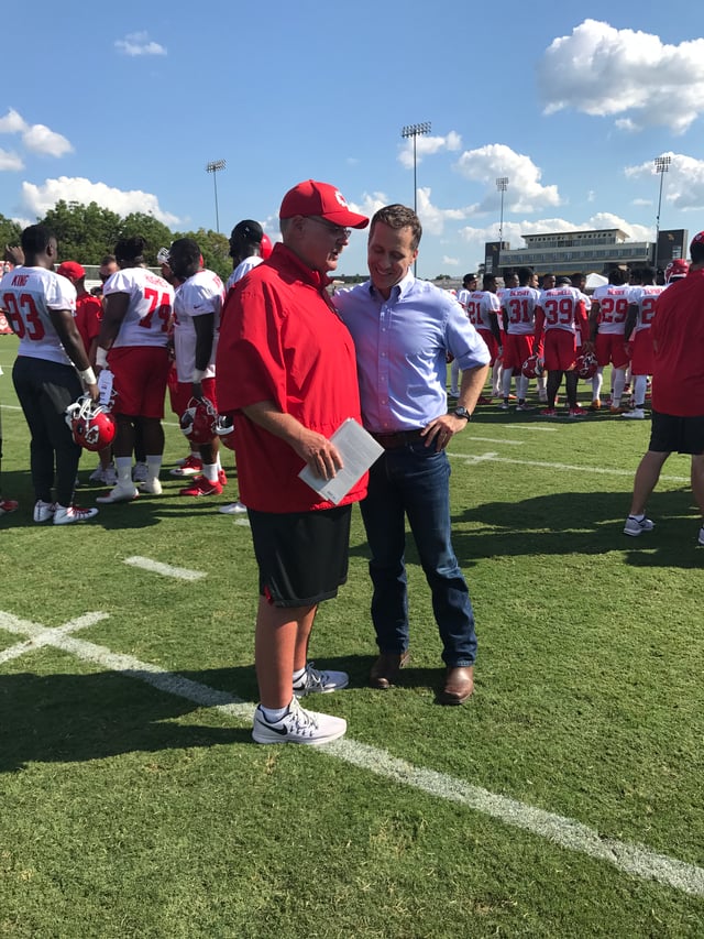 Governor Greitens and Kansas City Chiefs Coach Andy Reid on the field at KC Chiefs Training Camp in St. Joseph, Missouri in July 2017.