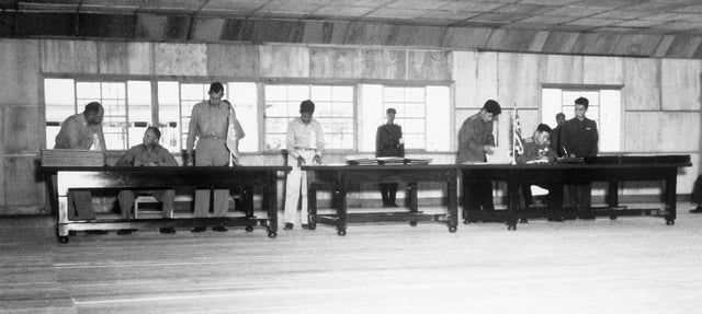 Delegates sign the Korean Armistice Agreement in P'anmunjŏm.