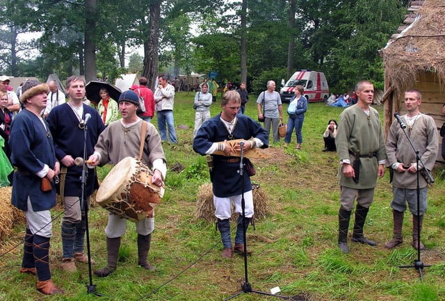 Latvian men's folk ensemble "Vilki" performing at the festival of Baltic crafts and warfare "Apuolė 854" in Apuolė Castle mound, August 2009