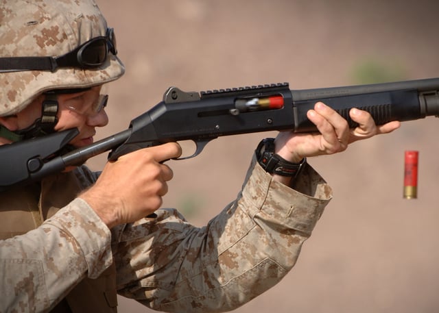 An American marine fires a Benelli M4 shotgun during training in Arta, Djibouti, 23 December 2006.