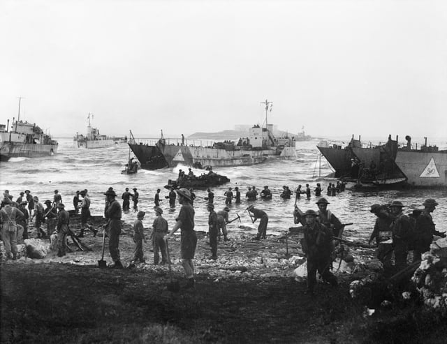 Troops from the 51st (Highland) Division unloading stores from tank landing craft on the opening day of the invasion of Sicily, 10 July 1943.