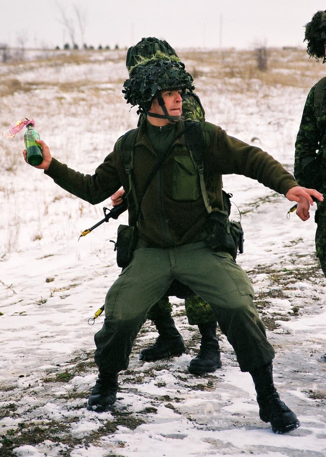 Soldier from the Canadian Armed Forces throwing a Molotov cocktail.
