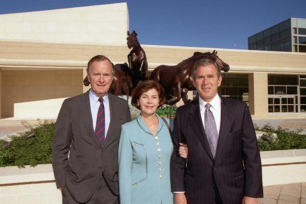 Governor Bush (right) with father, former president George H. W. Bush, and wife, Laura, in 1997