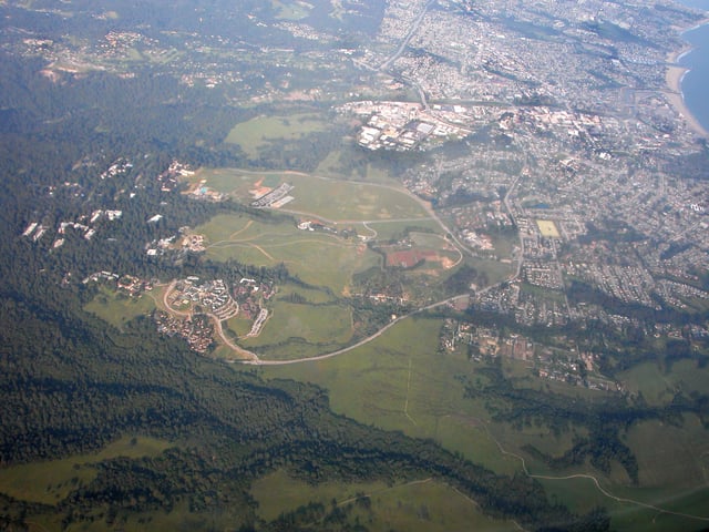 UCSC & Santa Cruz aerial view. The Great Meadow is the undeveloped area between city and university
