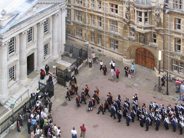 Graduands enter the Senate House at a graduation ceremony