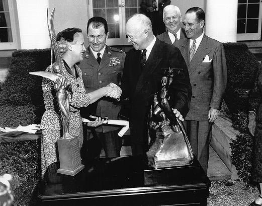 Cochran and Chuck Yeager being presented with the Harmon International Trophies by President Dwight Eisenhower