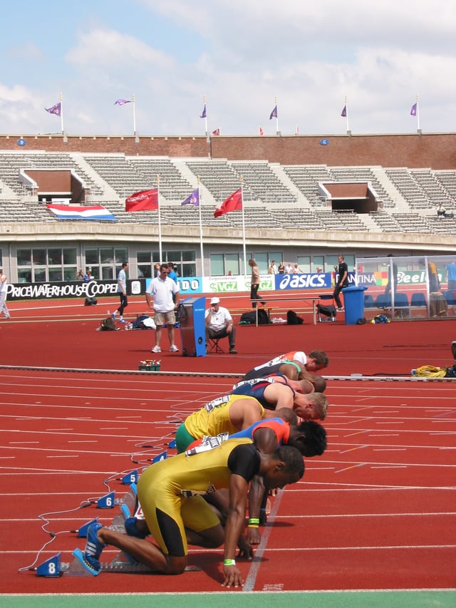 Men assuming the starting position for a sprint race