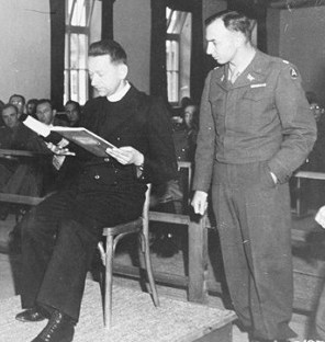 Prosecutor William Dowdell Denson examines a witness during the Dachau trials