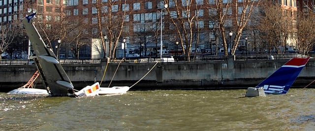 The partially submerged aircraft tied up alongside Battery Park City