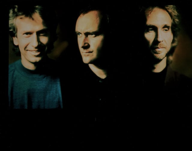 Collins with his two Genesis bandmates, Tony Banks (left) and Mike Rutherford (right) in 1991.