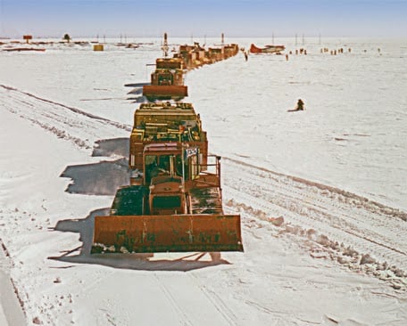 MCB 1 Sled train departing Little America for traverse to Byrd Station (646 miles) or the South Pole (850 miles). The Navy special ordered SD-LGP D8s (SD=stretched dozer, LGP=low ground pressure) with the frames extended 4 feet and tracks 54 inches wide resulting in a ground pressure of 4.30 psi and blades 18.5 feet wide. There were two types of sleds: 10 ton or 20 ton that could be hitched in multiples. (U.S. Navy).
