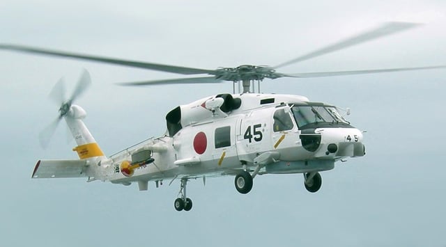 A JMSDF SH-60J lands on board USS Russell