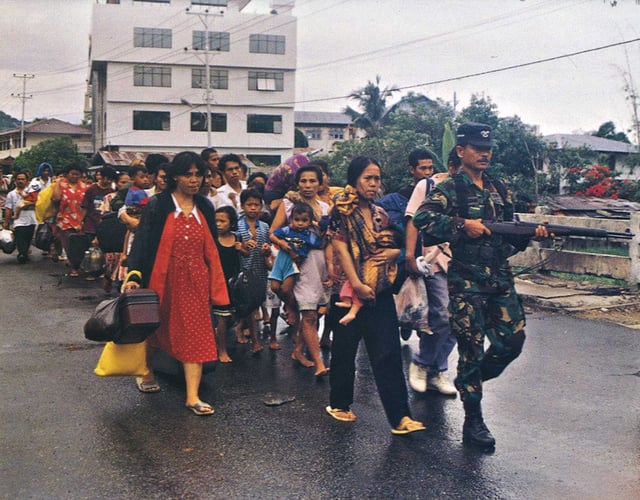 Indonesian military forces evacuate refugees of the Ambon religious riots.
