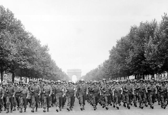 Men of the 28th Infantry Division marches down the Champs Élysées in Paris, 29 August 1944.