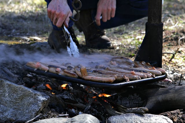 Australian "snags" cooking on a campfire