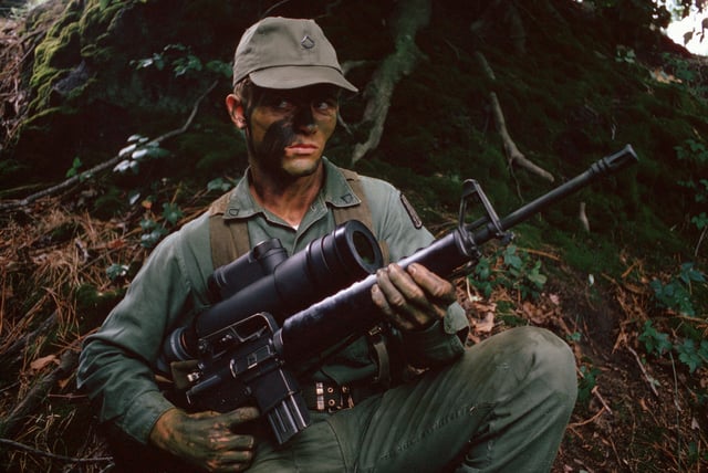 A Vietnam War-era infantryman armed with an M16A1 rifle and an AN/PVS-2 Starlight scope for use at night.