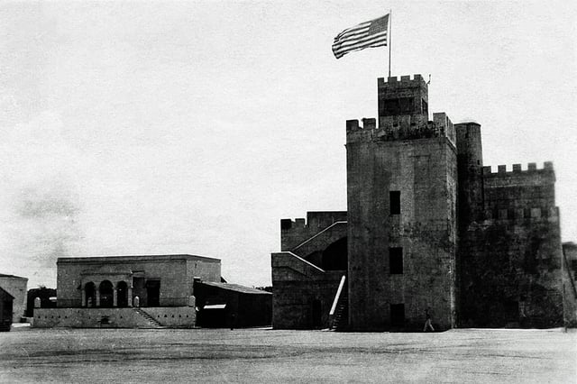 The flag of the United States waving over Ozama Fortress during the U.S. occupation of the Dominican Republic, c. 1922
