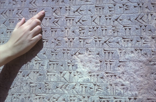 Old Persian inscribed in cuneiform on the Behistun Inscription.