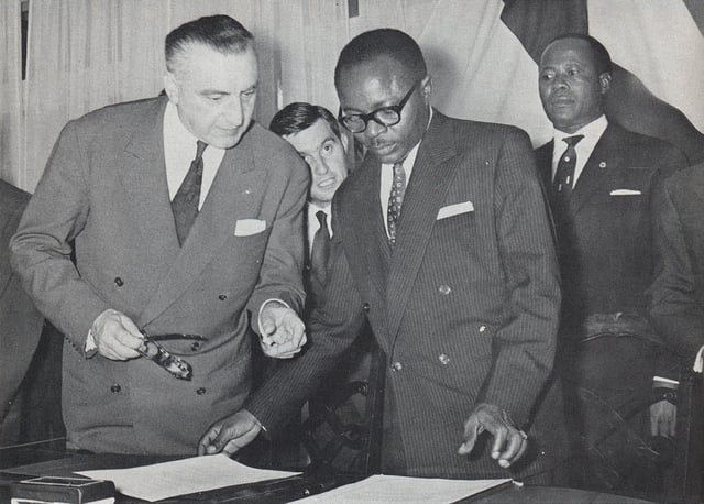 Maurice Yaméogo, the first President of Upper Volta, examines documents of ratifying the country's independence in 1960